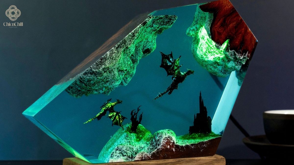 A handmade resin lamp featuring a glowing fantasy landscape, where dramatic light and sculptural textures create a bold, atmospheric statement for modern interiors.