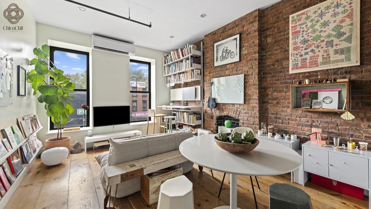 A thoughtfully curated brick wall brings warmth, texture, and personality to the living space.